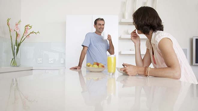 couple standing in kitchen with benchtop